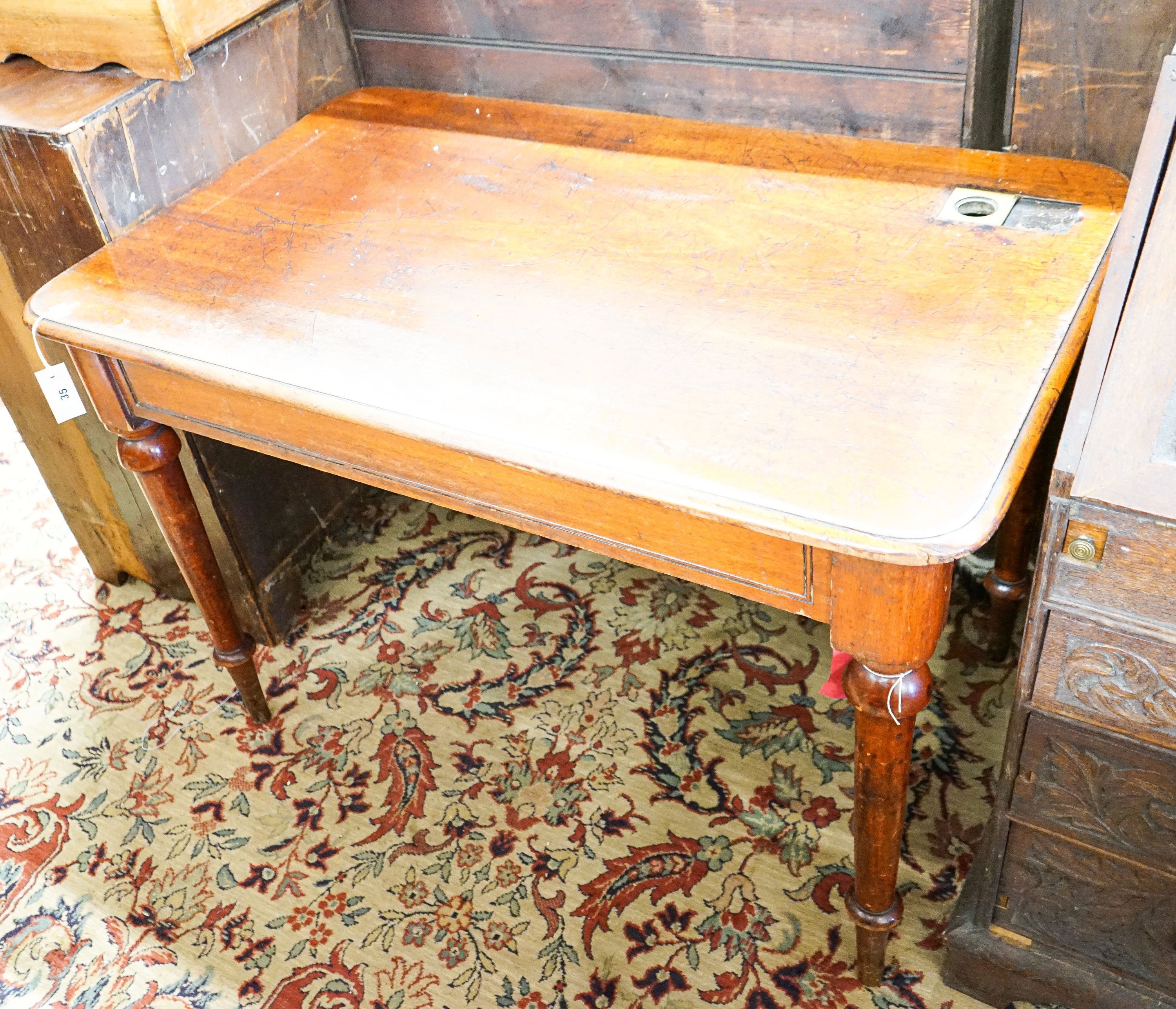 A Victorian rectangular mahogany writing table, from The Library of the Royal College of Surgeons, London, width 114cm, depth 68cm, height 77cm